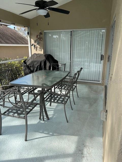 view of patio with outdoor dining space and a ceiling fan