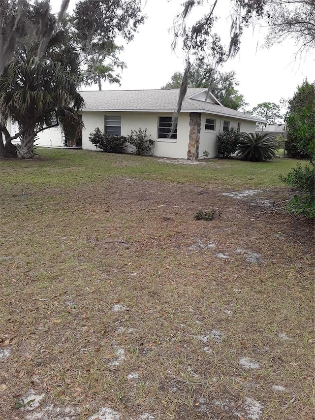 rear view of house with a yard