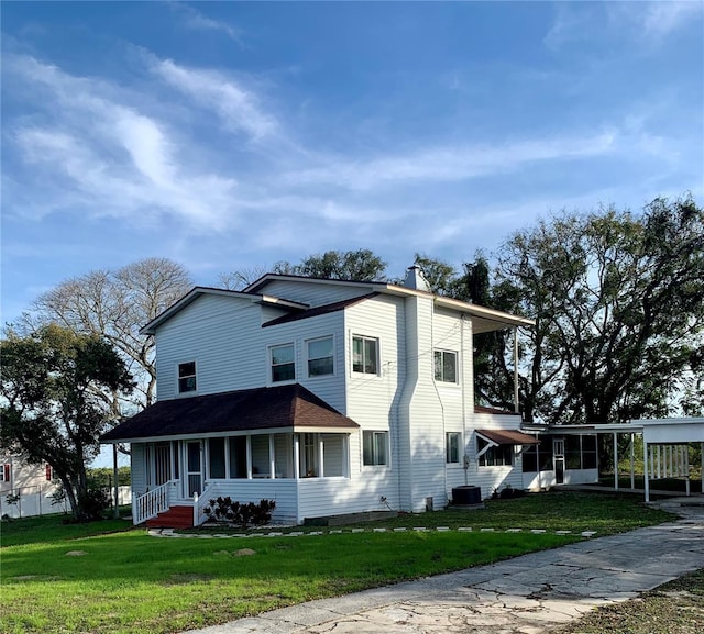 view of front of home with a carport and a front yard