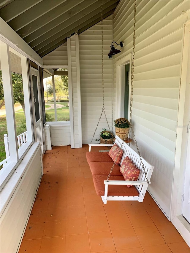 unfurnished sunroom featuring lofted ceiling