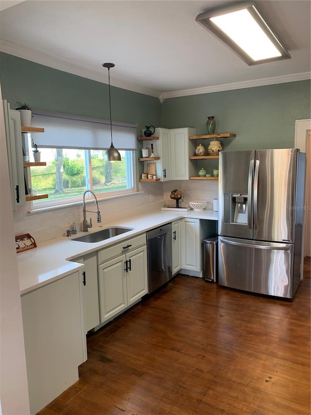 kitchen featuring decorative light fixtures, sink, stainless steel appliances, dark hardwood / wood-style floors, and white cabinetry