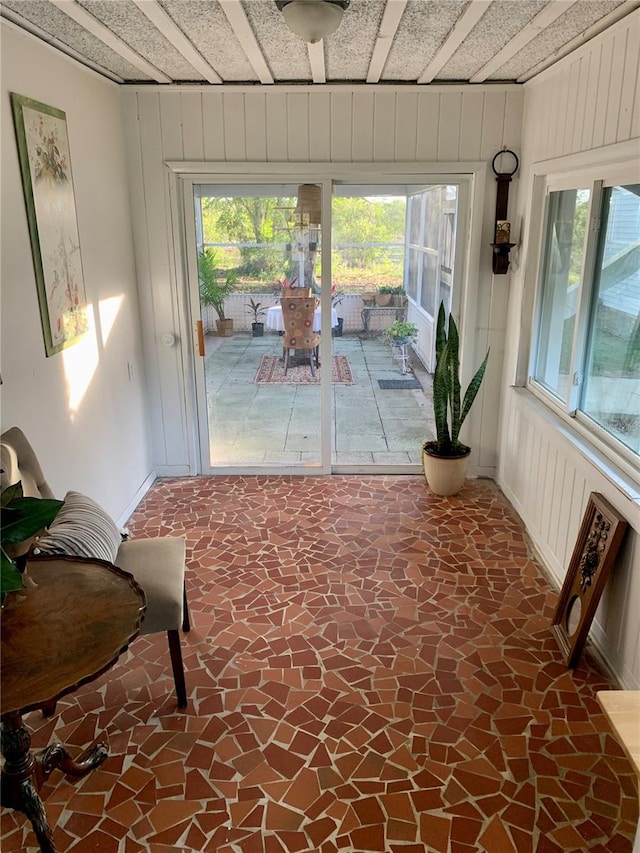 entryway with wood walls