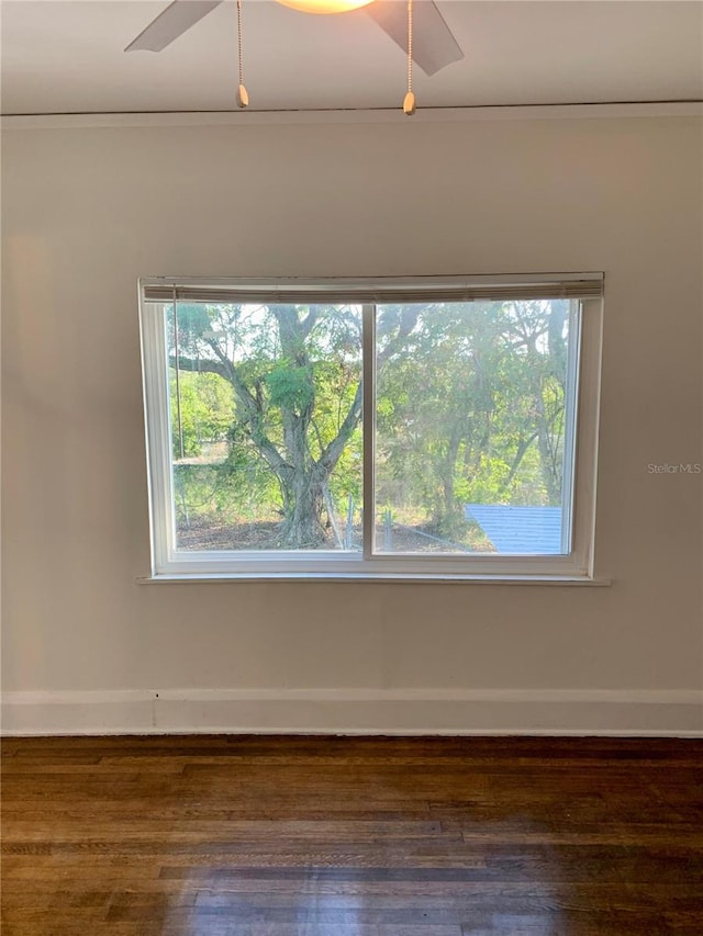 spare room featuring ceiling fan, ornamental molding, and dark hardwood / wood-style flooring