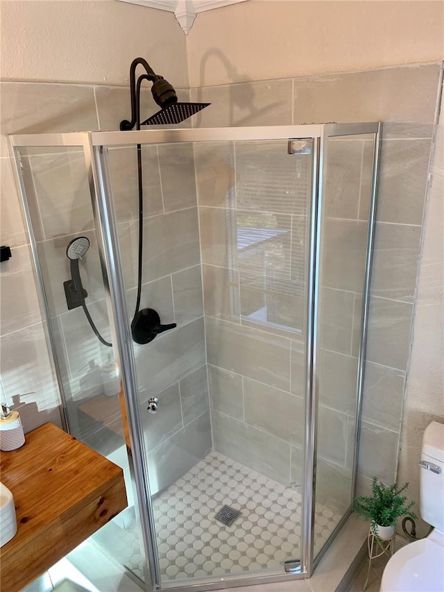 bathroom with an enclosed shower and toilet