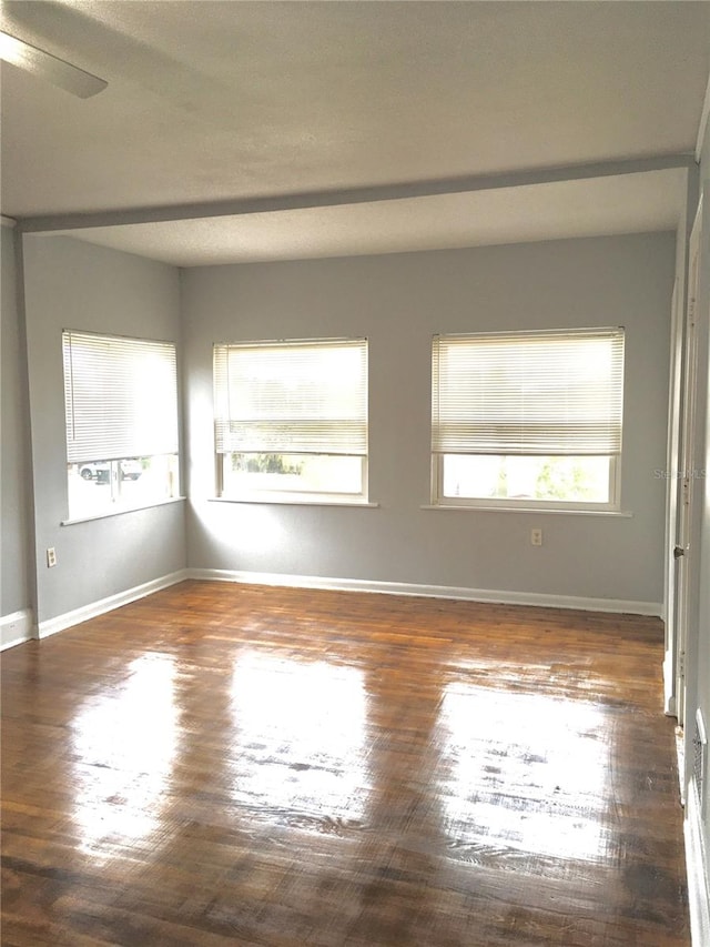 spare room with ceiling fan and dark hardwood / wood-style floors