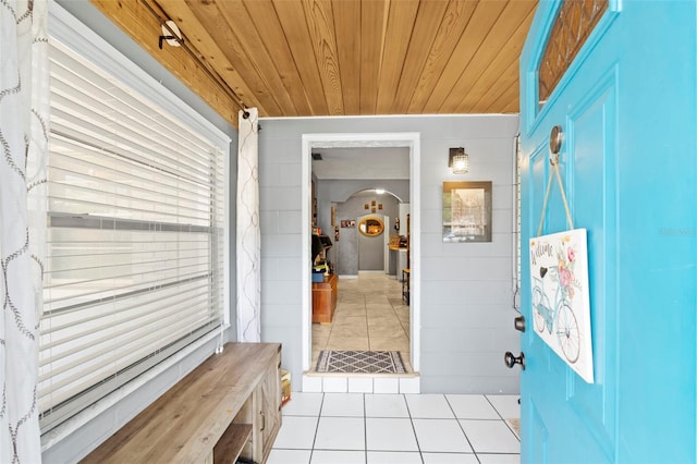 hall with wooden ceiling and light tile flooring