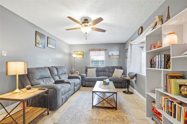 tiled living room featuring a textured ceiling and ceiling fan