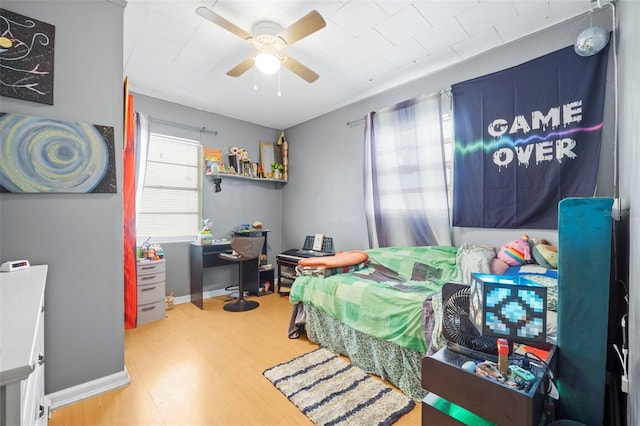 bedroom with ceiling fan and hardwood / wood-style flooring