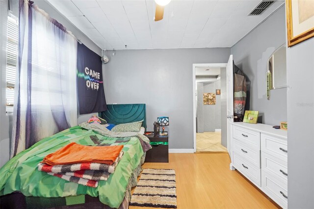 bedroom with ceiling fan and light wood-type flooring