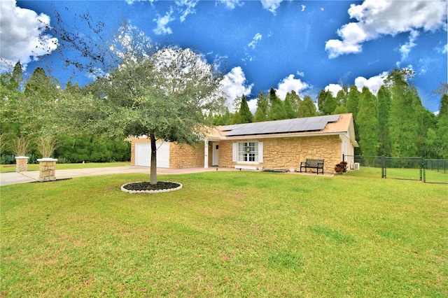 ranch-style house featuring solar panels and a front lawn