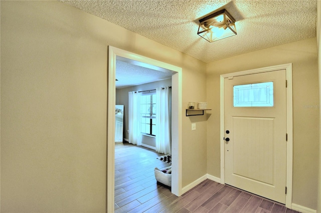 entrance foyer featuring hardwood / wood-style floors and a textured ceiling