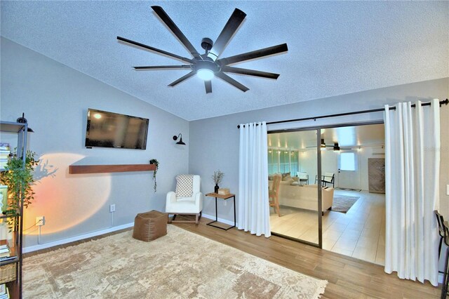 sitting room with light tile floors, a textured ceiling, and ceiling fan