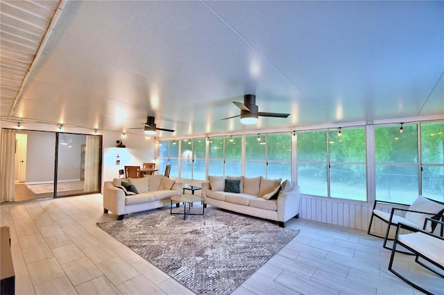 living room featuring ceiling fan and light wood-type flooring
