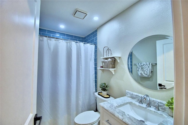 bathroom with toilet and vanity with extensive cabinet space