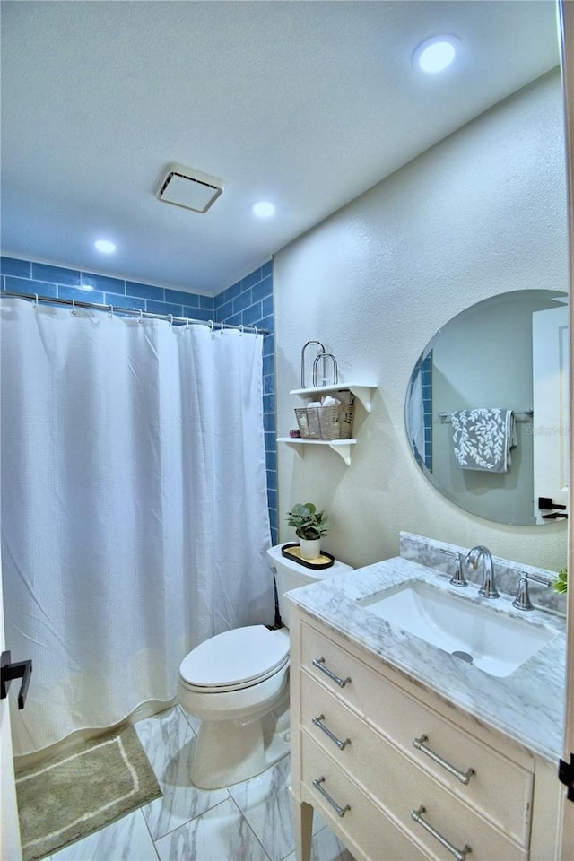 bathroom with vanity, tile flooring, and toilet