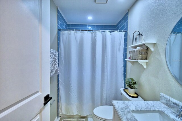 bathroom featuring toilet and large vanity