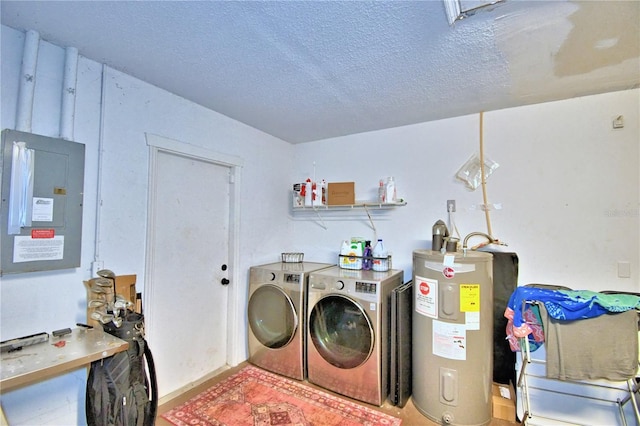 clothes washing area with a textured ceiling, water heater, and independent washer and dryer