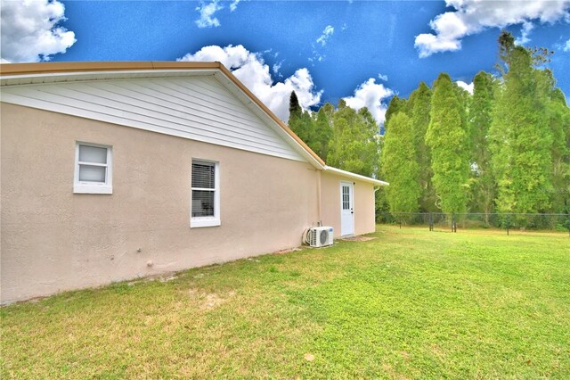 view of home's exterior with a lawn