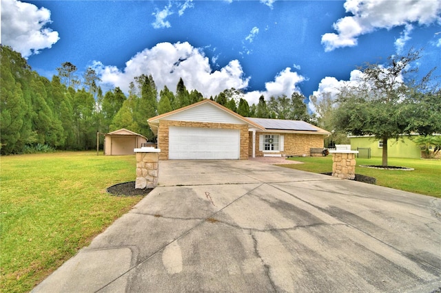 ranch-style home with solar panels, a front lawn, and a garage