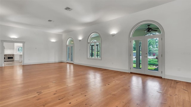 2300 N Scenic Hwy Unit 111, Lake Wales, FL 33898 - unfurnished living room with light wood-style floors, a ceiling fan, and french doors