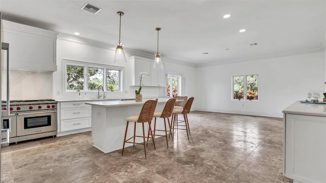 2300 N Scenic Hwy Unit 111, Lake Wales, FL 33898 - kitchen featuring premium stove, a center island, light countertops, white cabinets, and crown molding