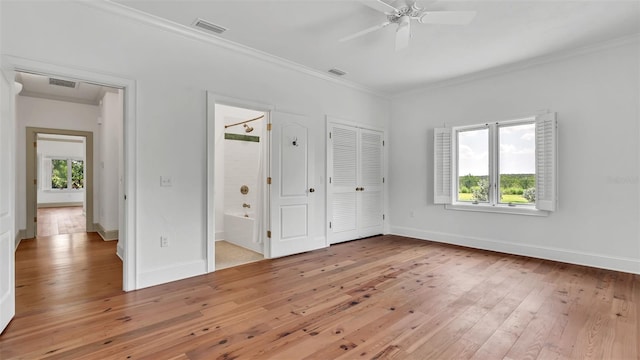 2300 N Scenic Hwy Unit 111, Lake Wales, FL 33898 - unfurnished bedroom with multiple windows, light wood-type flooring, ornamental molding, and connected bathroom