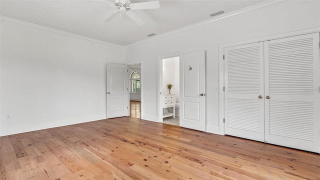 2300 N Scenic Hwy Unit 111, Lake Wales, FL 33898 - unfurnished bedroom featuring crown molding, hardwood / wood-style floors, connected bathroom, a closet, and a ceiling fan