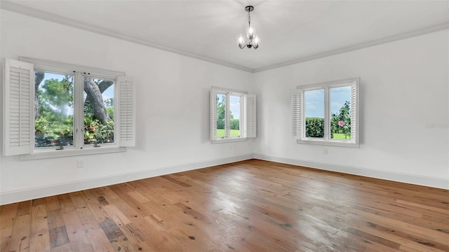 2300 N Scenic Hwy Unit 111, Lake Wales, FL 33898 - spare room with healthy amount of natural light, a chandelier, wood-type flooring, and crown molding
