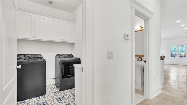 2300 N Scenic Hwy Unit 111, Lake Wales, FL 33898 - laundry room with separate washer and dryer, cabinet space, and light tile patterned floors