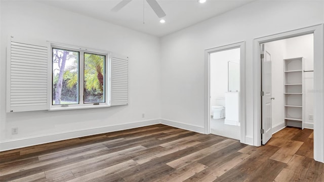2300 N Scenic Hwy Unit 111, Lake Wales, FL 33898 - unfurnished bedroom with dark wood-type flooring, recessed lighting, connected bathroom, a spacious closet, and a closet