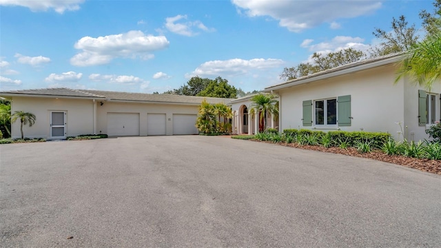 2300 N Scenic Hwy Unit 111, Lake Wales, FL 33898 - ranch-style house featuring an attached garage, asphalt driveway, and stucco siding