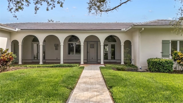 2300 N Scenic Hwy Unit 111, Lake Wales, FL 33898 - doorway to property featuring a yard, a tiled roof, and covered porch