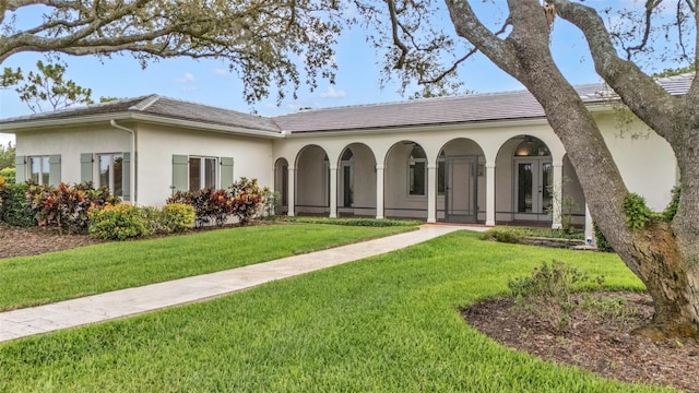 2300 N Scenic Hwy Unit 111, Lake Wales, FL 33898 - rear view of house featuring a yard, stucco siding, and a tile roof