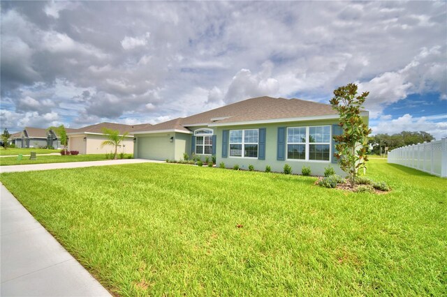 ranch-style house with a front yard and a garage