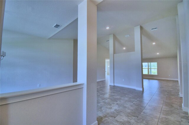 empty room with lofted ceiling