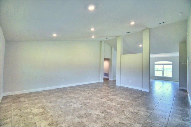 spare room featuring high vaulted ceiling