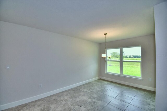 unfurnished room with an inviting chandelier