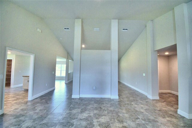 empty room featuring high vaulted ceiling