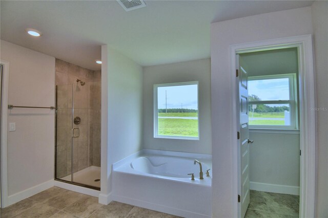 bathroom with plenty of natural light and shower with separate bathtub