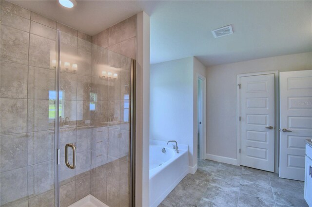 bathroom featuring shower with separate bathtub