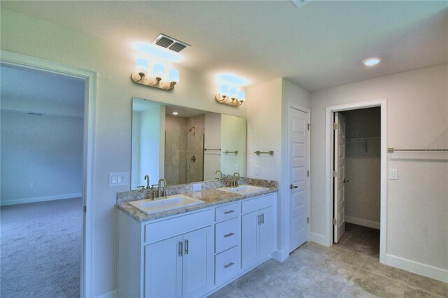 bathroom featuring walk in shower and vanity