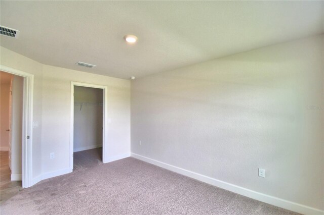 unfurnished bedroom with carpet flooring and a closet