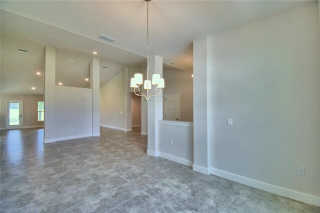 unfurnished room with an inviting chandelier and lofted ceiling