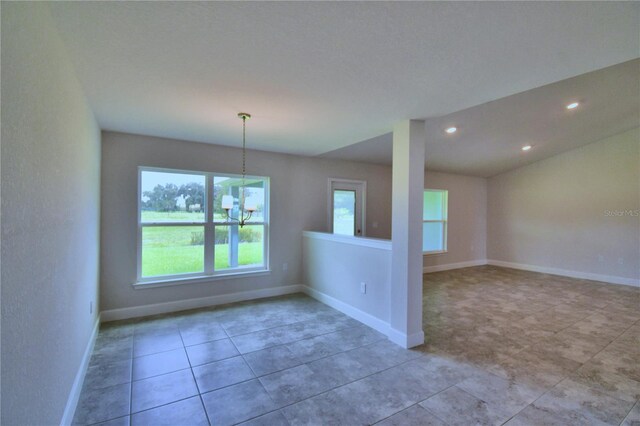 spare room featuring a notable chandelier