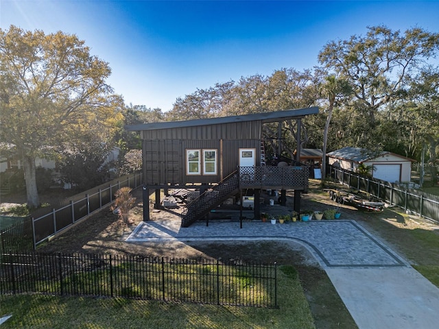 rear view of house with a yard and a deck