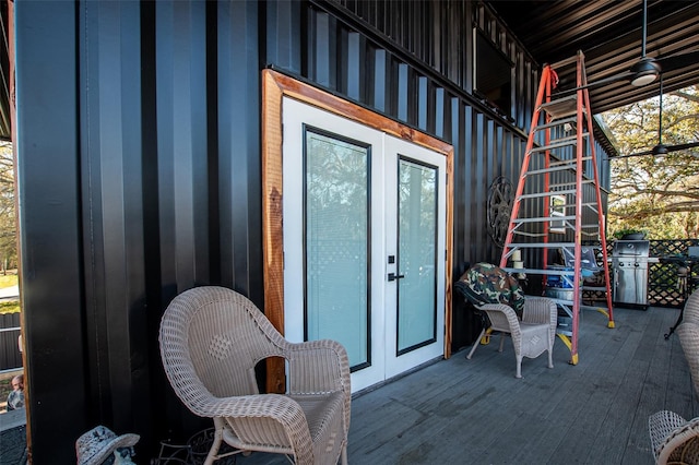 wooden balcony with a wooden deck and french doors