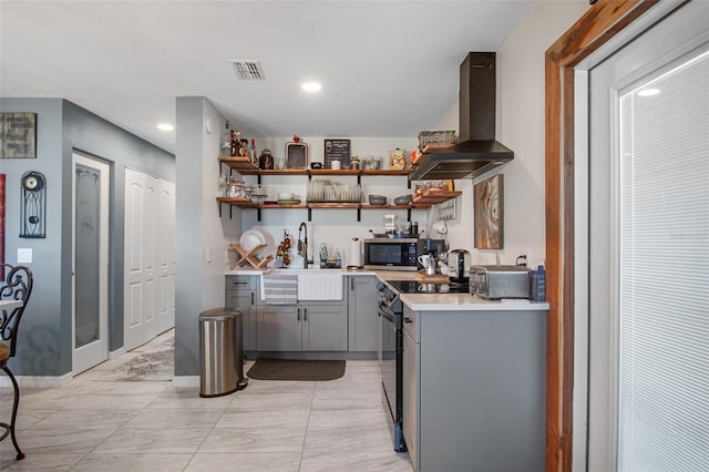 kitchen with light tile flooring, sink, wall chimney exhaust hood, gray cabinets, and electric range oven