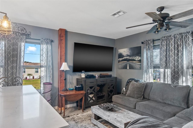 living room featuring hardwood / wood-style floors and ceiling fan