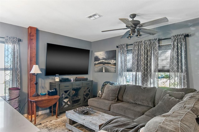 living room with ceiling fan and light hardwood / wood-style flooring