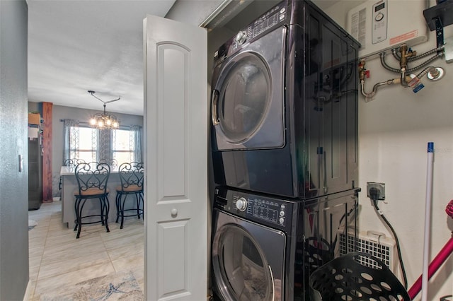 clothes washing area featuring light tile floors, stacked washer and dryer, a chandelier, and water heater